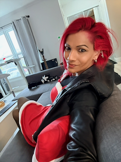 _r0ze with vibrant red hair wearing a VR headset